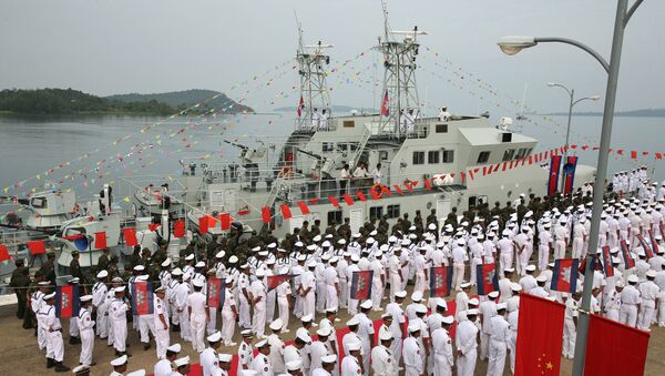Cambodian naval personel stand as they wait for the welcoming delegation for a handover ceremony for nine naval patrol boats donated by China, at the Cambodia Naval Base in Sihanouk Ville, some 220 kilometers south-west of Phnom Penh, 07 November 2007. - Sputnik International