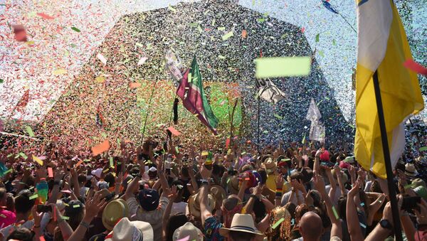 Revellers cheer as Australian singer Kylie performs at the Glastonbury Festival of Music and Performing Arts on Worthy Farm near the village of Pilton in Somerset, South West England, on June 30, 2019 - Sputnik International