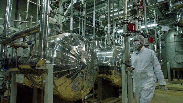  An Iranian security official, dressed in protective clothing, walks inside the Uranium Conversion Facility, just outside the city of Isfahan, 410 kilometers, (255 miles), south of the Iranian capital Tehran in this Wednesday, March 30, 2005 - Sputnik International