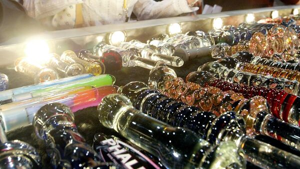 A woman looks at a glass dildo made by Phallix at the AVN Adult Entertainment Expo 09 January, 2004 in Las Vegas - Sputnik International