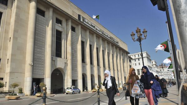 In this photo taken on Thursday, March 2, 2017, Algerian women pass by the People's National Assembly building in Algiers, Algeria - Sputnik International
