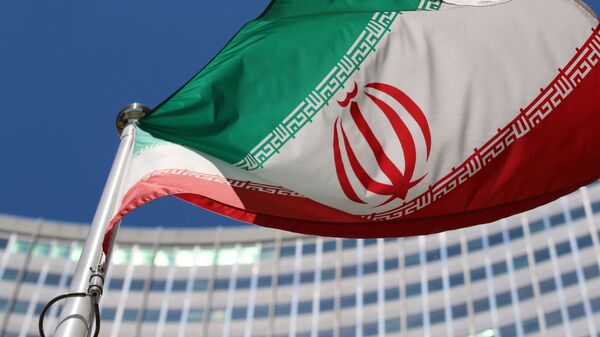 The Iranian flag flies in front of a UN building where closed-door nuclear talks take place at the International Center in Vienna, Austria, Wednesday, June 18, 2014 - Sputnik International