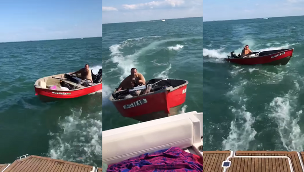Timothy Kennedy, seen operating the red skiff, faces charges of operating while intoxicated (OWI) and malicious destruction of property.  - Sputnik International