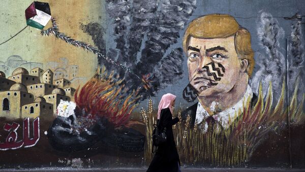 A wall with graffiti depicts U.S. President Donald Trump with a footprint on his face in Gaza City, Tuesday, June 25, 2019 - Sputnik International