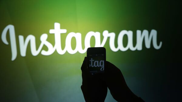 A journalist makes a video of the Instagram logo using the new video feature at Facebook headquarters in Menlo Park, Calif., Thursday, June 20, 2013 - Sputnik International