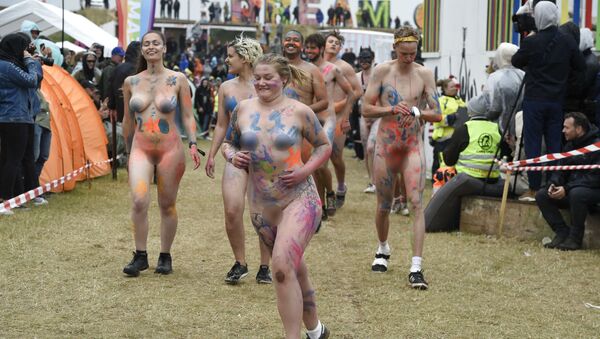 People take part in a Naked Run on the sidelines of the Roskilde Festival on 4 July 2019 in Denmark - Sputnik International