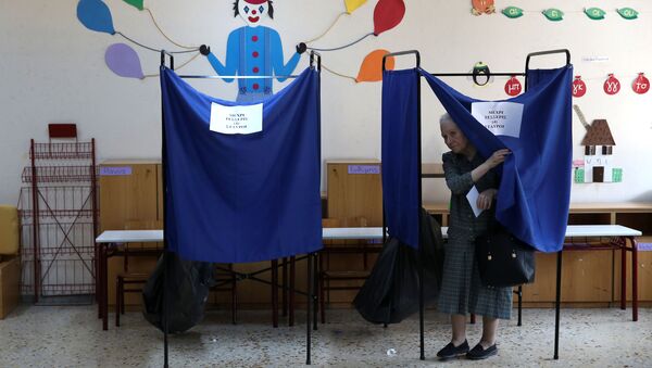 A woman leaves a voting booth to cast her ballot for the general election in Athens, Greece, July 7, 2019. - Sputnik International