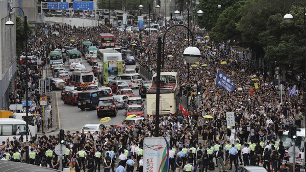Police block the road ahead of a march by protesters in Hong Kong on Sunday, July 7, 2019. - Sputnik International