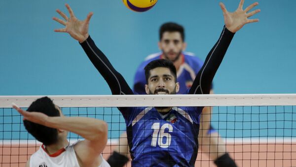 Iran's Ali Safiei plays against Korea during their men's volleyball gold medal match at the 18th Asian Games in Jakarta, Indonesia, Saturday, Sept. 1, 2018. Iran won gold. - Sputnik International