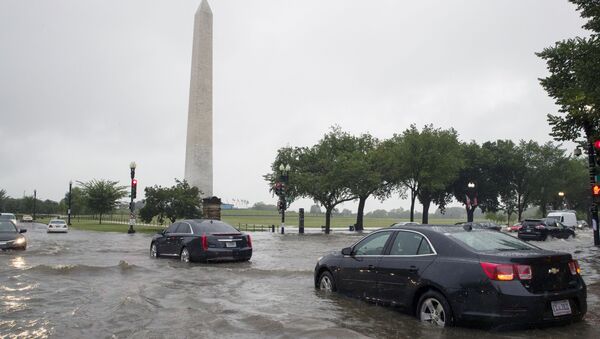 Heavy rainfall flooded the intersection of 15th Street and Constitution Ave., NW stalling cars in the street, Monday, July 8, 2019, in Washington near the Washington Monument. - Sputnik International