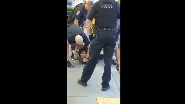 Maryland's Montgomery County Police Department initiates investigation after cellphone video surfaces, showing officer smash a handcuffed teenager's face to the cement ground. - Sputnik International
