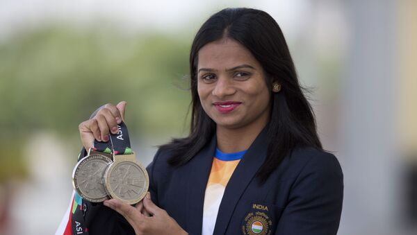 Indian sprinter Dutee Chand displays her silver medals during a press conference in Hyderabad, India, Saturday, Sept. 1, 2018 - Sputnik International