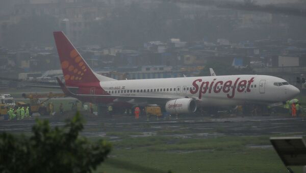 A domestic Spice Jet aircraft is seen off the runway after it skidded off into the unpaved surface during heavy rains in Mumbai, India - Sputnik International