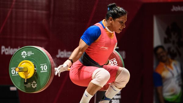 India's Rakhi Halder takes part in the women's 63kg Group A weightlifting event at the 2018 Asian Games in Jakarta on August 24, 2018. (Photo by ANTHONY WALLACE / AFP) - Sputnik International