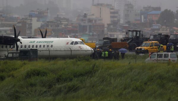 A Yeti Airlines plane lies near the runway after it skidded off while landing at Tribhuvan International Airport in Kathmandu, Nepal July 12, 2019 - Sputnik International