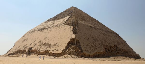 People walk in front of the Bent Pyramid of Sneferu, that was reopened after restoration work, in Dahshur, south of Cairo, Egypt July 13, 2019. People walk in front of the Bent Pyramid of Sneferu, that was reopened after restoration work, in Dahshur, south of Cairo, Egypt July 13, 2019. - Sputnik International