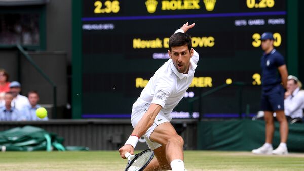Serbia's Novak Djokovic returns against Switzerland's Roger Federer during their men's singles final on day thirteen of the 2019 Wimbledon Championships  - Sputnik International