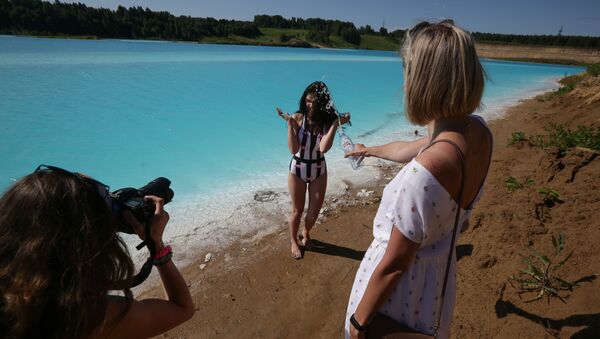 A young woman poses for pictures by a Novosibirsk energy plant's ash dump site - nicknamed the local Maldives - on 11 July 2019. - Sputnik International