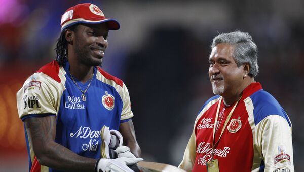 Royal Challengers Bangalore team owner Vijay Mallya, right, shares a light moment with cricketer Chris Gayle as the rain delayed the start of the Indian Premier League (IPL) cricket match between Royal Challengers Bangalore and Chennai Super Kings' in Bangalore, India, Wednesday, April 25, 2012 - Sputnik International