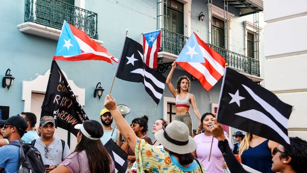 Demonstrators chant and wave Puerto Rican flags during the fourth day of protest calling for the resignation of Governor Ricardo Rossello in San Juan, Puerto Rico July 16, 2019. - Sputnik International