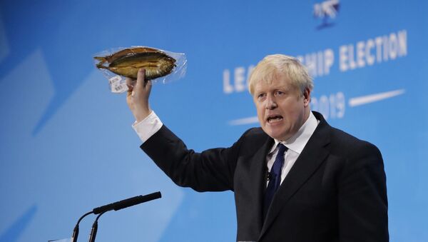 Conservative MP and leadership contender Boris Johnson holds up kipper fish in plastic packaging as he speaks at the final Conservative Party leadership election hustings in London, on July 17, 2019 - Sputnik International