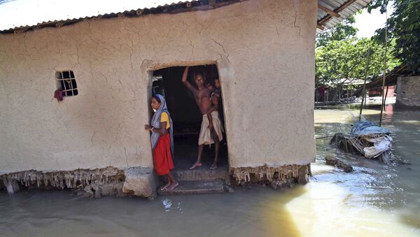 Villagers stand inside their house destroyed by floodwaters at Katihar district, in the eastern Indian state of Bihar (File) - Sputnik International