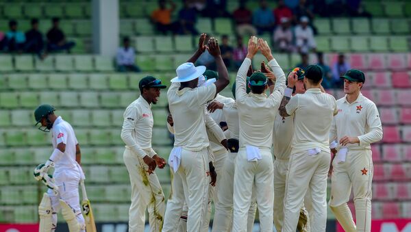Zimbabwe's team celebrates the dismissal of the Bangladesh's Liton Das (L) during the fourth day of the first Test cricket match between Bangladesh and Zimbabwe in Sylhet on November 6, 2018 - Sputnik International