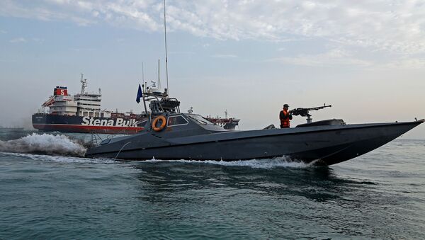 A boat of the Iranian Revolutionary Guard sails next to Stena Impero, a British-flagged vessel owned by Stena Bulk, at Bandar Abbas port, July 21, 2019 - Sputnik International