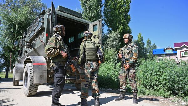 Indian army soldiers stands near the site of a gun battle between a suspected militant and Indian government forces in Kanipora area of Nowgam in central Kashmir's Budgam district on June 28, 2019 - Sputnik International