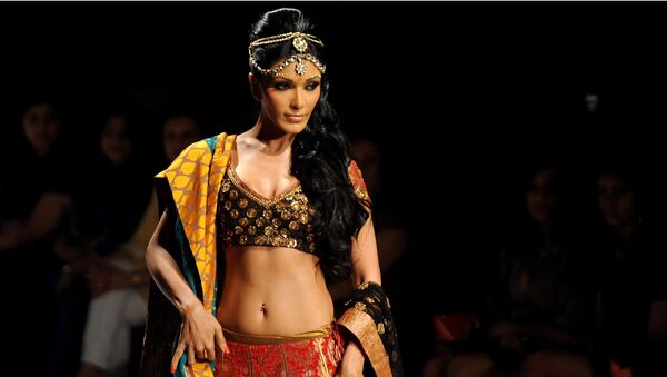Indian Bollywood Actress Koena Mitra presents a creation by Indian designer Joy Mitra during the Wills India Fashion Week Autumn-Winter 2010 in New delhi on March 26, 2010 - Sputnik International