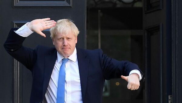 Boris Johnson gestures as he arrives at the Conservative Party headquarters, after being announced as Britain's next Prime Minister, in London, Britain July 23, 2019 - Sputnik International