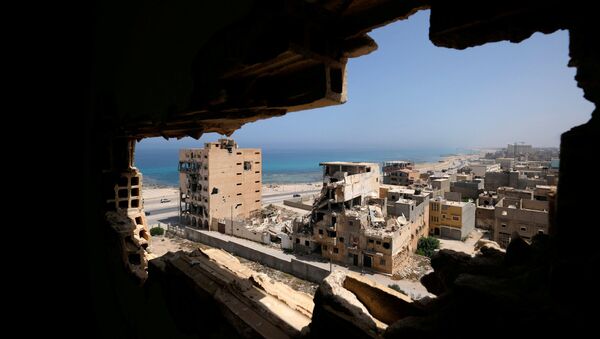 Destroyed buildings are seen through a hole in Benghazi lighthouse after it was severely damaged by years of armed conflict, in Benghazi, Libya July 10, 2019 - Sputnik International