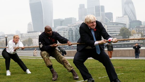 London Mayor Boris Johnson takes part in a tug of war with members of the armed services to launch the London Poppy Day, outside City Hall, in London, October 27, 2015 - Sputnik International