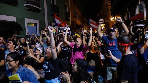 Demonstrators celebrate after the resignation of Puerto Rico Governor Ricardo Rossello in San Juan, Puerto Rico, July 24, 2019 - Sputnik International