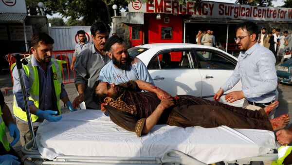 Men carry an injured man to a hospital after a blast in Kabul, Afghanistan July 28, 2019.  - Sputnik International