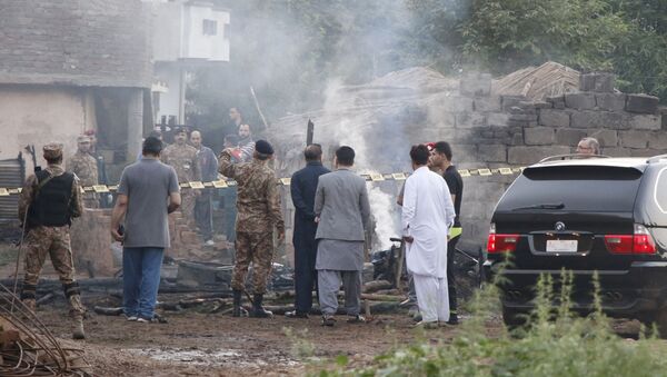 Pakistani soldiers and officers survey the site after a military aircraft on a training flight crashed in the garrison city of Rawalpindi, Pakistan, 30 July 2019 - Sputnik International