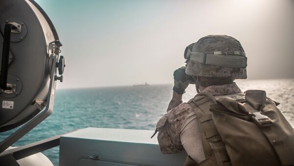 U.S. Marine Corps Cpl. Michael Weeks, ranges nearby boats from USS John P. Murtha during a Strait of Hormuz transit, Arabian Sea off Oman, in this picture released by U.S. Navy on July 18, 2019 - Sputnik International