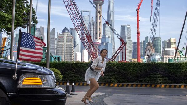 A woman sprints past a U.S. embassy car outside a hotel in Shanghai Tuesday, July 30, 2019  - Sputnik International