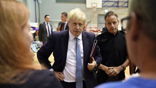 Britain's Prime Minister Boris Johnson meets with rescue crews and local residents during a visit to Chapel-en-le-Frith High School near the village of Whaley Bridge in Derbyshire, England - Sputnik International