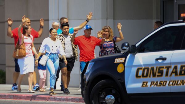 Shoppers exit with their hands up after a mass shooting at a Walmart in El Paso, Texas, U.S. August 3, 2019 - Sputnik International