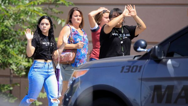 Shoppers exit with their hands up after a mass shooting at a Walmart in El Paso, Texas, U.S. August 3, 2019. REUTERS/Jorge Salgado - Sputnik International