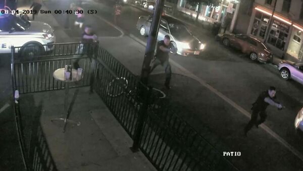 Police officers approach the scene of a mass shooting with weapons drawn in a still image from surveillance video released by police in Dayton, Ohio, U.S. August 4, 2019 - Sputnik International