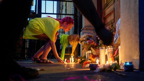 A mourner leaves a candle at the scene of a mass shooting in Dayton, Ohio, U.S. August 4, 2019 - Sputnik International