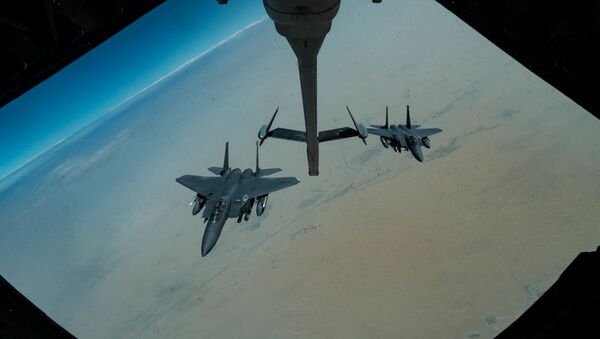F-15E Strike Eagles assigned to the 336th Expeditionary Fighter Squadron approaches a KC-10 Extender for refuelling, at an undisclosed location in Gulf, during a surface combat air patrol mission, in this undated handout picture released by U.S. Air Force on June 27, 2019 - Sputnik International