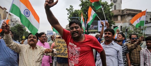 People shout slogans as they celebrate after the government scrapped the special status of Kashmir, in Ahmedabad, India, August 5, 2019 People shout slogans as they celebrate after the government scrapped the special status of Kashmir, in Ahmedabad, India, August 5, 2019 - Sputnik International