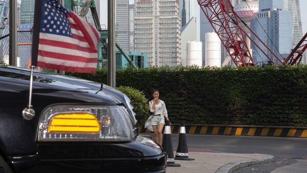 A woman walks towards a US embassy car outside a hotel in Shanghai on 30 July 2019 - Sputnik International
