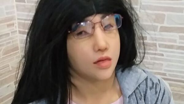 This photo, released by the Rio de Janeiro Penitentiary Administration Secretariat, shows a man who authorities identify as jailed Brazilian drug trafficker Clauvino da Silva, alias “Baixinho,” which means Shorty, wearing a mask, wig, glasses and feminine clothing, as his hands are confined behind his back at a prison complex in Rio de Janeiro, Brazil, 4 August 2019 - Sputnik International