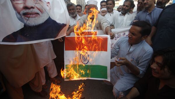 Pakistanis burn a representation of an Indian flag and a poster of Indian Prime Minster Narendra Modi during a protest to express support and solidarity with Indian Kashmiri people in their peaceful struggle for their right to self-determination, in Peshawar, Pakistan, Monday, 5 August 2019. - Sputnik International
