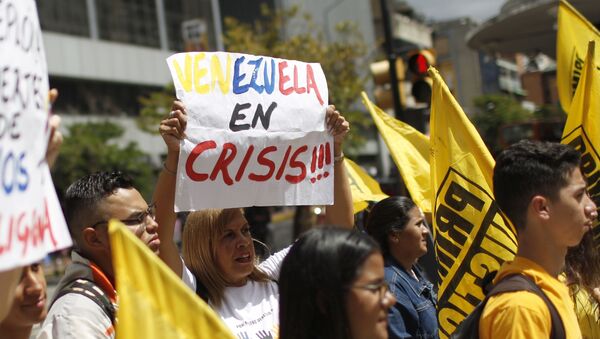 People protest against the Sao Paulo Forum in Caracas, Venezuela, Friday, July 26, 2019. Venezuela is hosting leftist activists from around Latin America at the forum that has been criticized by opponents who say the fragile country can hardly afford to entertain hundreds of international guests. - Sputnik International
