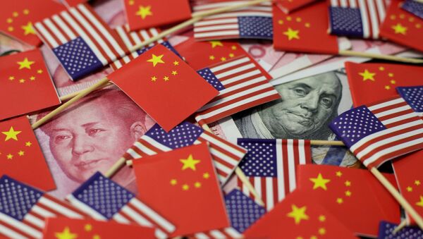 A U.S. dollar banknote featuring American founding father Benjamin Franklin and a China's yuan banknote featuring late Chinese chairman Mao Zedong are seen among U.S. and Chinese flags in this illustration picture taken May 20, 2019 - Sputnik International